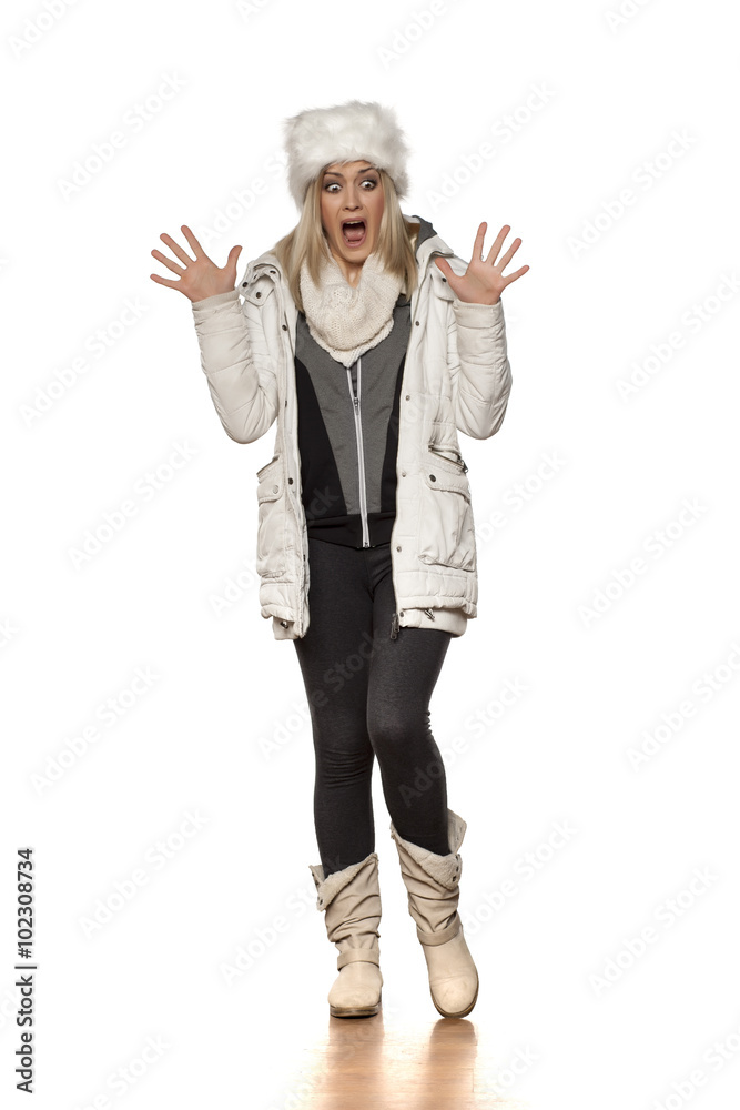 frightened young woman in winter clothes frightened young woman in winter clothes