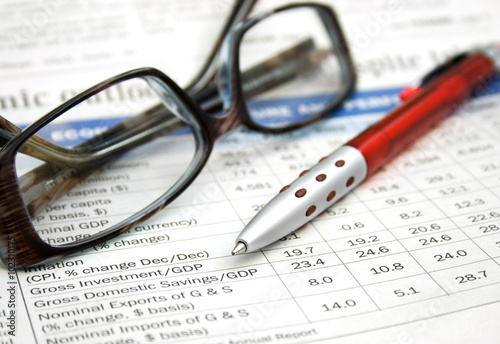 glasses and pen on financial report