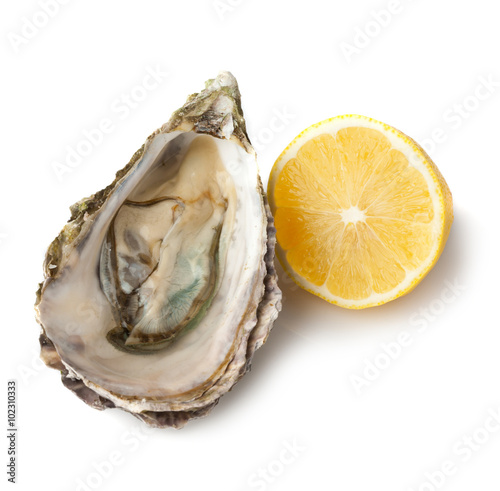 Fresh opened oyster with lemon on white background