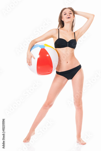 Girl posing in bikini with beach ball