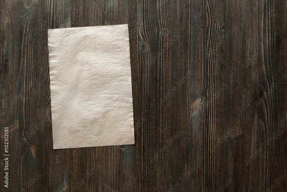 paper on old wooden background