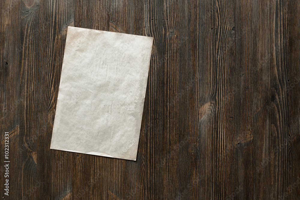 paper on old wooden background