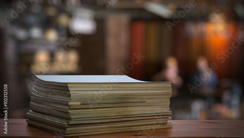 stack of old magazines on wooden table