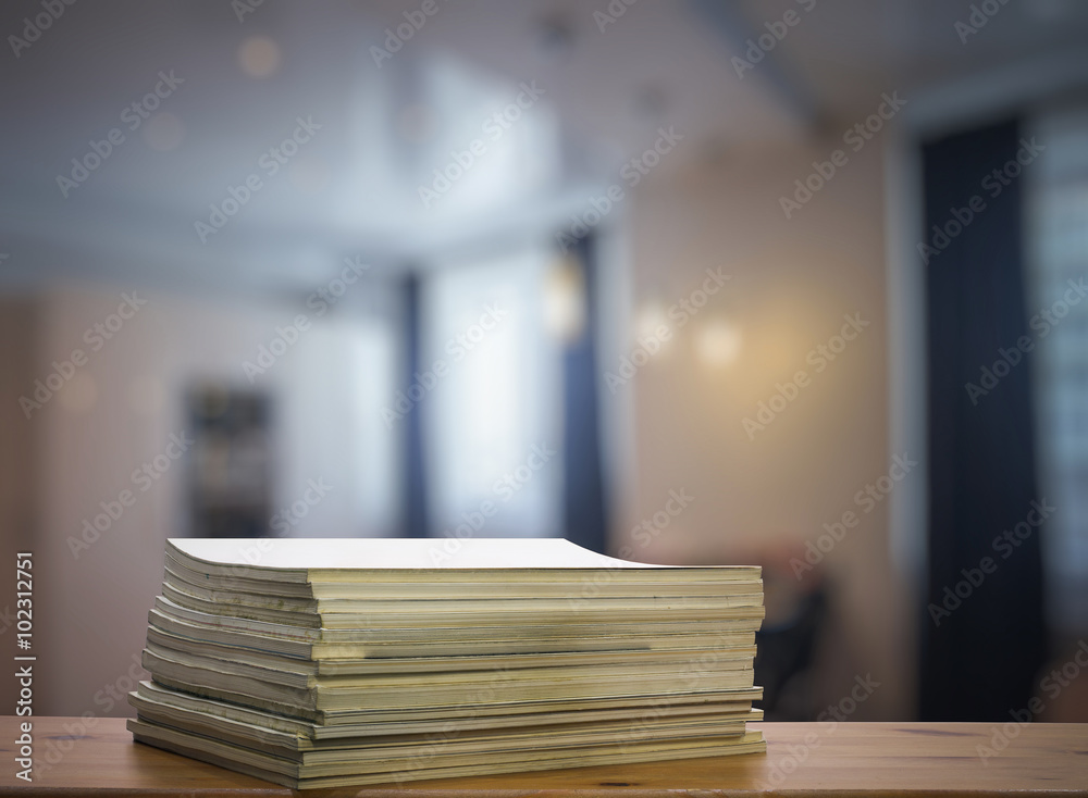 stack of old magazines on wooden table stack of old magazines on wooden table