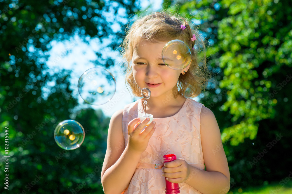 portrait of a beautiful girl with soap bubbles