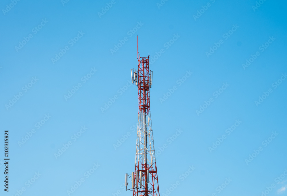 Telecommunication tower with antennas with blue sky background