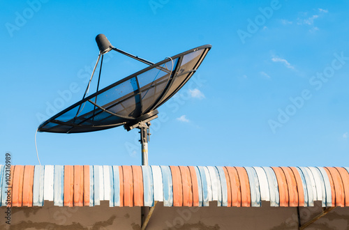 Big Black Satellite Dish on the roof with blue sky