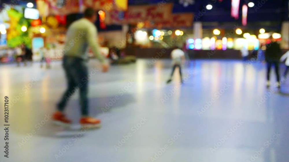 Teens, children on roller skates, roller skating, romantic active leisure in the entertainment center in the skating-rink 