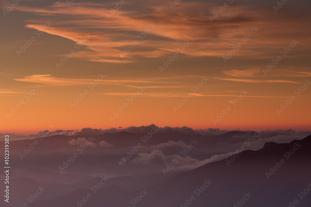 Red sunset over clouds and mountain Red sunset over clouds and mountain