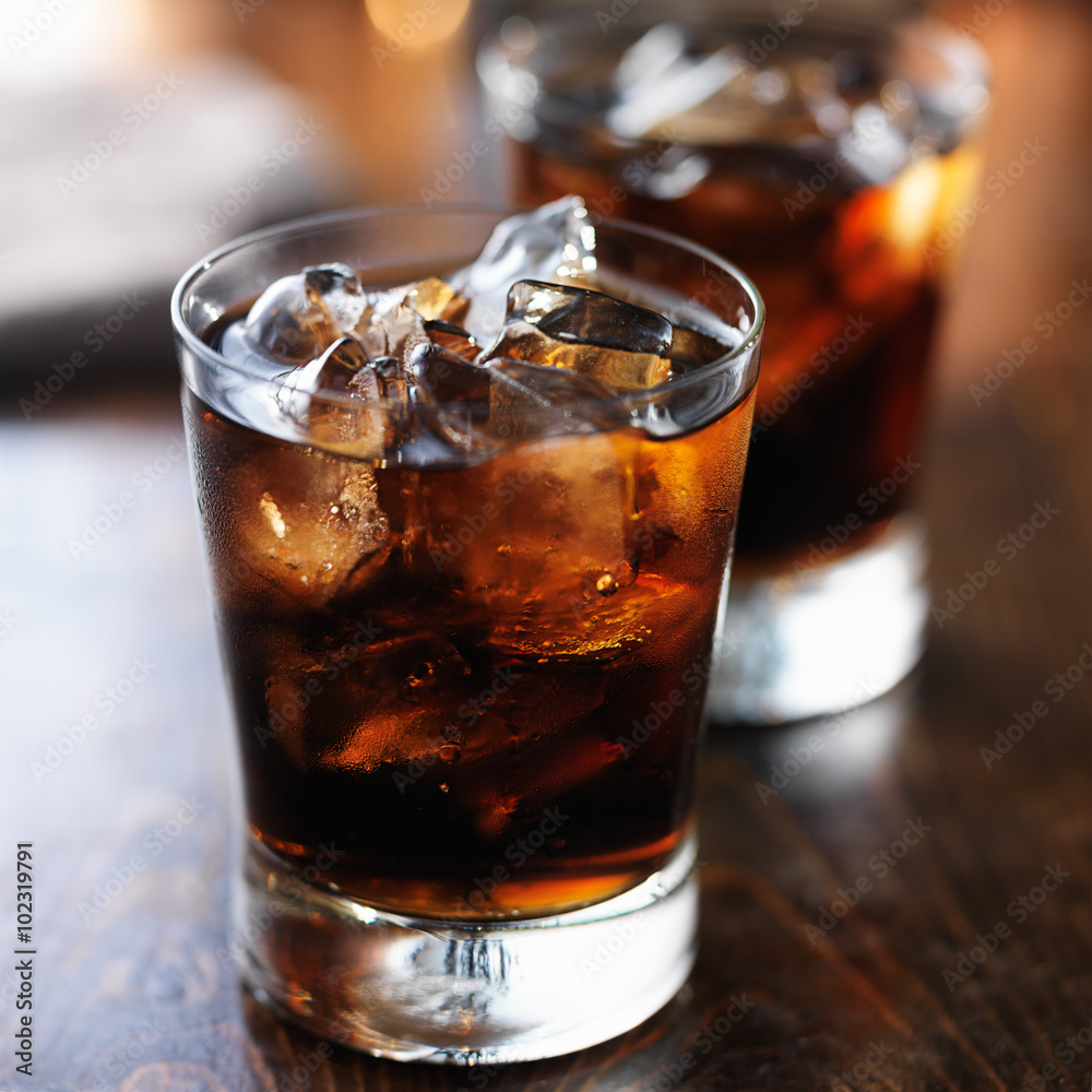 two cold cups of cola soda pop with ice two cold cups of cola soda pop with ice