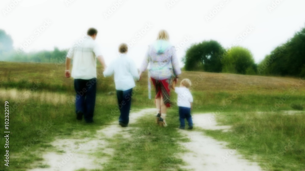 Happy cheerful full family, Caucasian parents and two children boys walking in countryside, non-urban Happy cheerful full family, Caucasian parents and two children boys walking in countryside, non-urban
