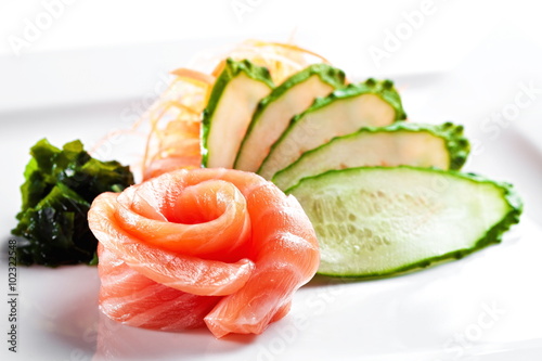 Salmon sashimi with cucumber on a white background 