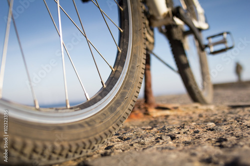 Close up on a bike parked in front of the seaside