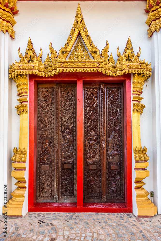 Exterior design in religion art of the Buddhist temple doors. The doors of Wat Nong Waeng in Khon Kaen province, Thailand.