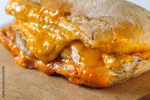 Tasty chicken steak sandwich in a ciabatta with cheddar cheese and thick romanian garlic sauce