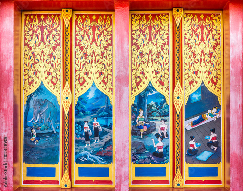 Vintage painting design on ancient wooden doors. The door entrance of Buddhist temple is at Wat Nong Waeng in Khon Kaen province, Thailand. © joeyphoto
