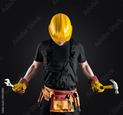 construction worker in helmet with hammer and wrench