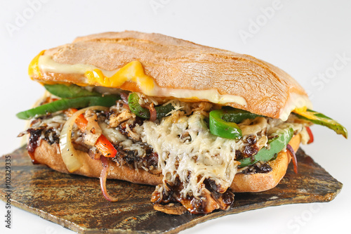 Tasty vegetarian sandwich in a ciabatta on a wodden plate
