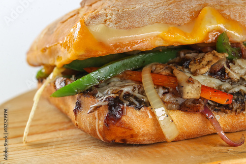 Tasty vegetarian sandwich in a ciabatta on a wodden plate photo