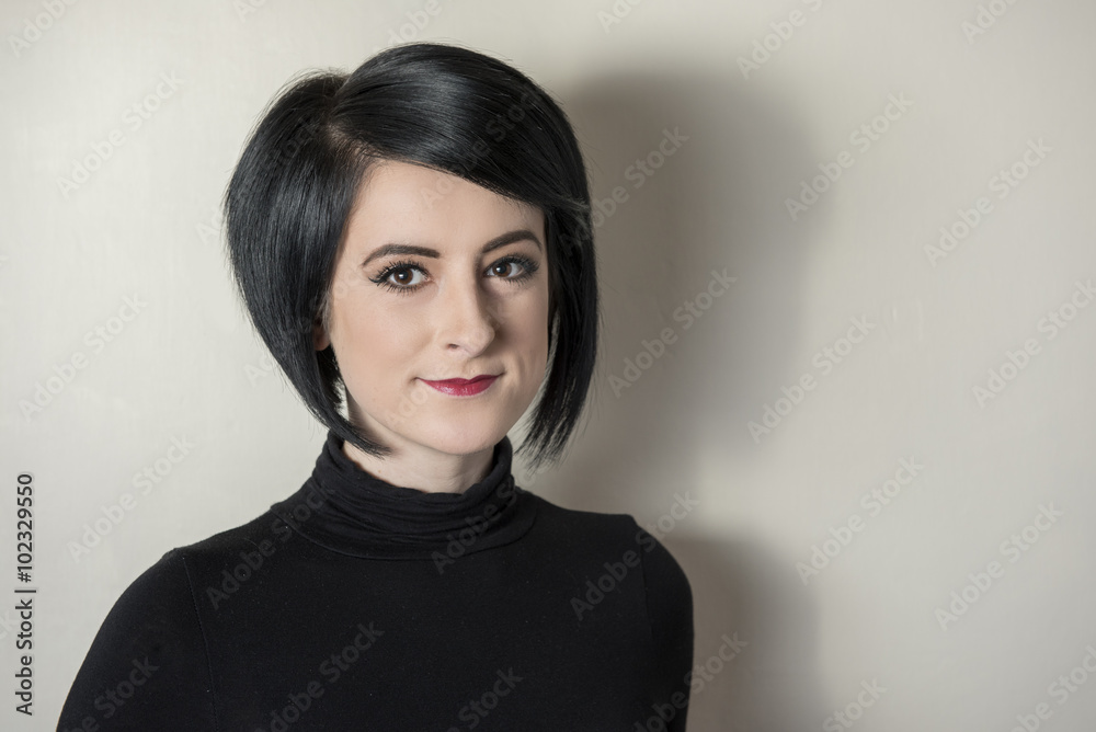 Portrait image of a smiling young female looking into the camera. Taken on a white background with copy space. Portrait image of a smiling young female looking into the camera. Taken on a white background with copy space.