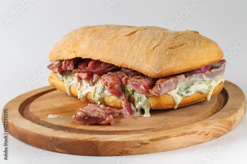 Tasty tuna steak sandwich in a ciabatta with lettuce, onions, Marie Rose sauce and lemon juice