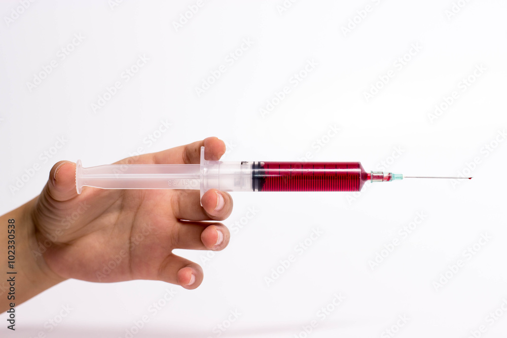 Syringe in hand Syringe in hand