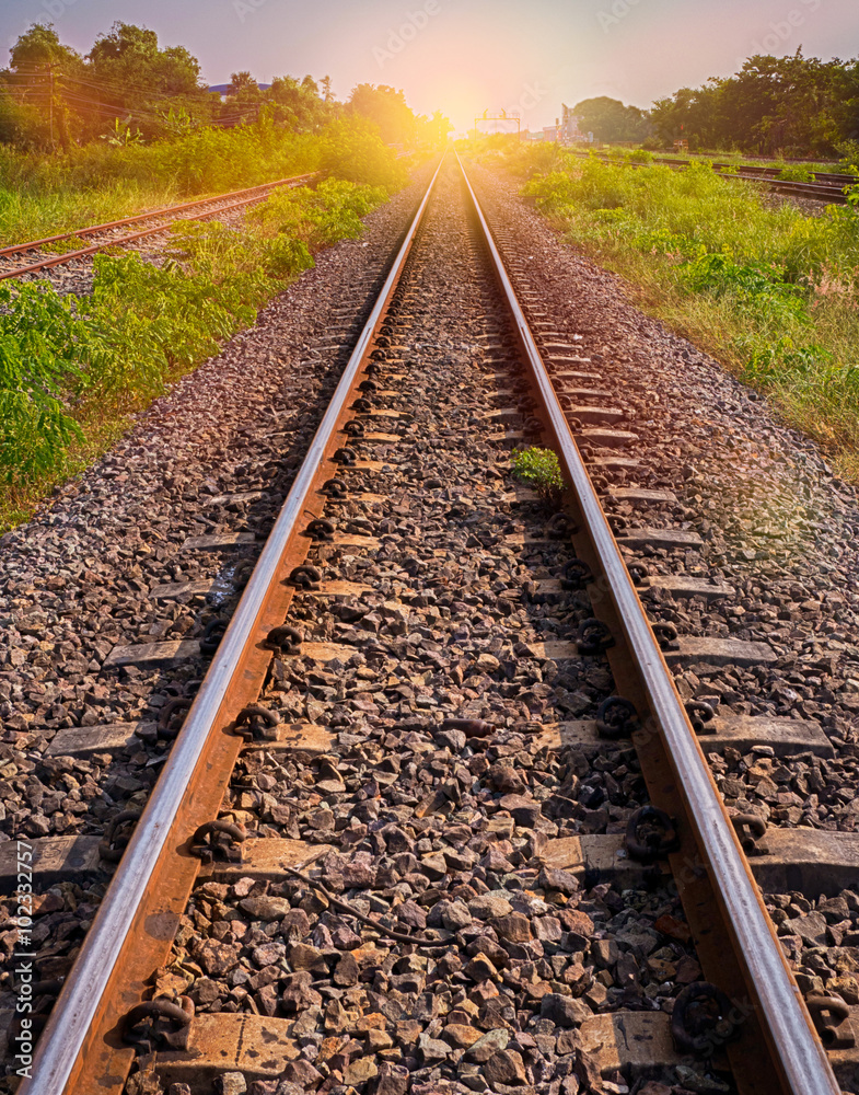 railway tracks in sun raise moment with flair of sun