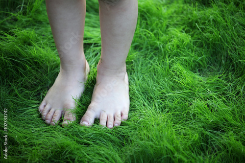 children foot on green grass © sakhorn38