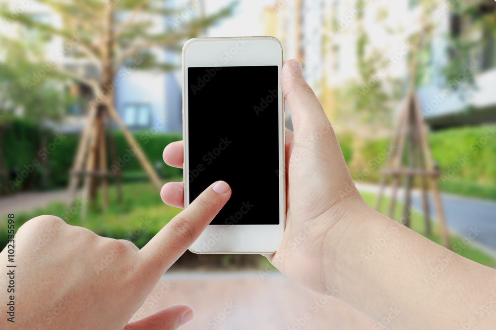 Woman hand touching smartphone