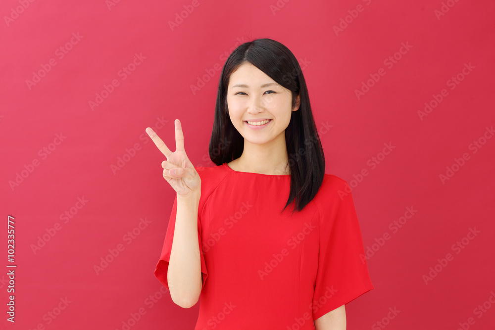 ピース若い女性・赤背景 ピース若い女性・赤背景