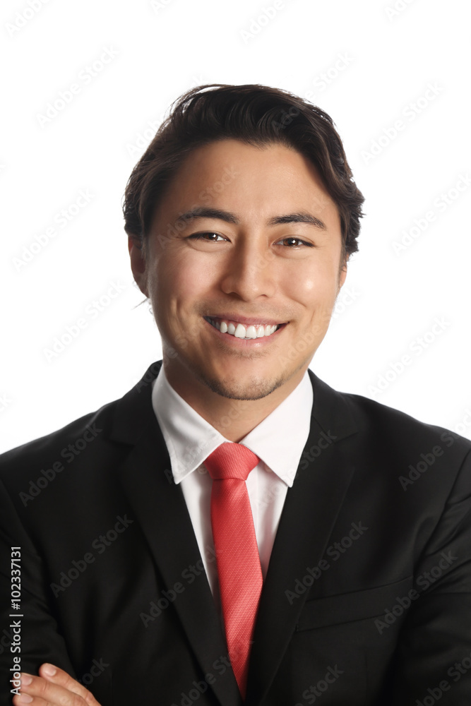 Smiling businessman in a black suit with a red tie. Looking at camera standing against a white background. Smiling businessman in a black suit with a red tie. Looking at camera standing against a white background.