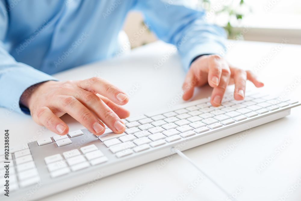 Men office worker typing on the keyboard Men office worker typing on the keyboard