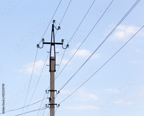 Mast electrical power line against cloud and blue sky