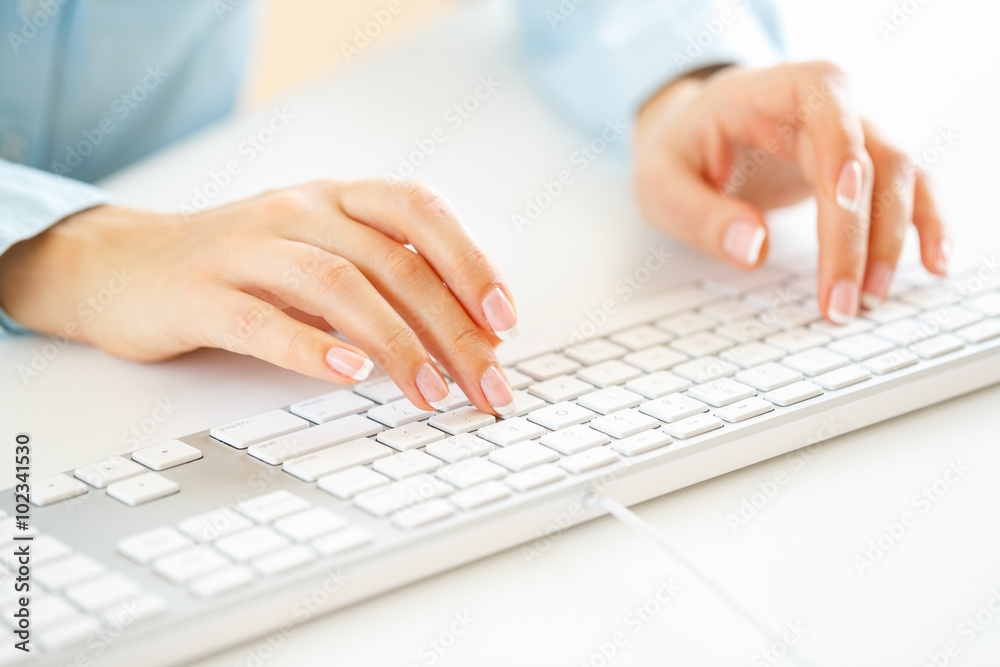 Woman office worker typing on the keyboard Woman office worker typing on the keyboard