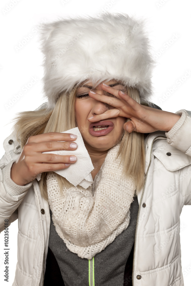 cold young beautiful woman in winter clotes wipes his nose with a handkerchief cold young beautiful woman in winter clotes wipes his nose with a handkerchief