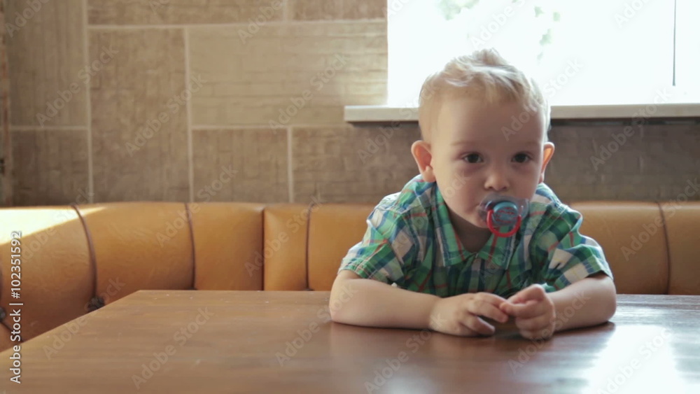 2 years old boy at an empty table 2 years old boy at an empty table