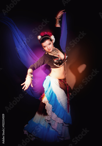 Beautiful exotic belly tribal dancer woman with blue shawl