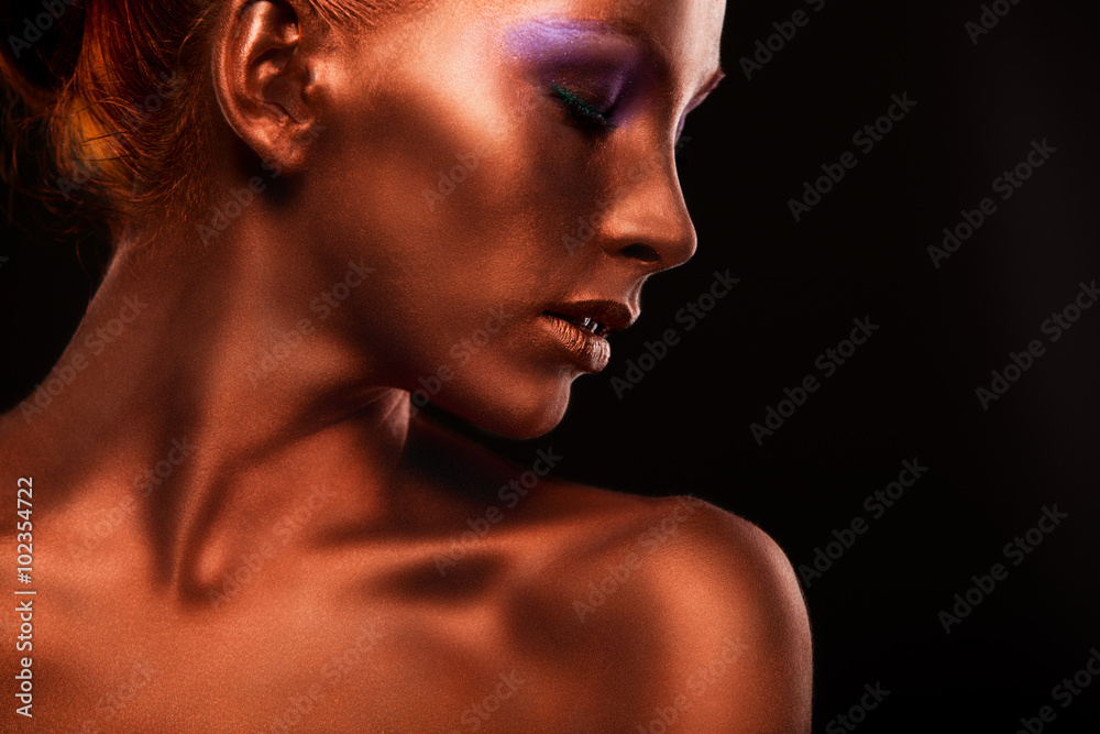 Gilt. Golden Woman's Face Closeup. Futuristic Gilded Make-up. Painted Skin bronze. Gilt. Golden Woman's Face Closeup. Futuristic Gilded Make-up. Painted Skin bronze.
