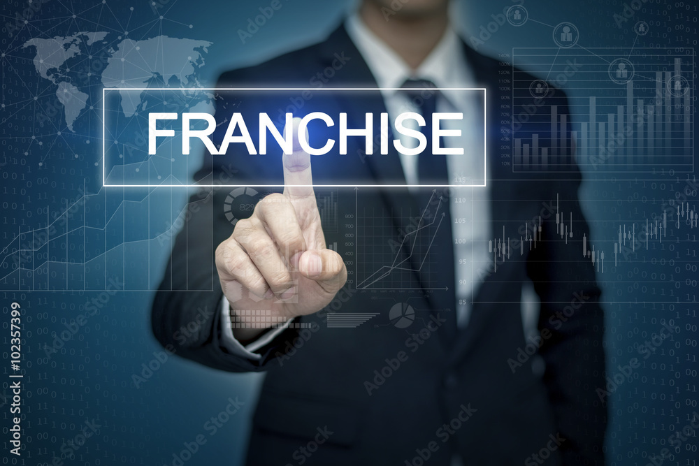 Businessman hand touching FRANCHISE button on virtual screen Businessman hand touching FRANCHISE button on virtual screen