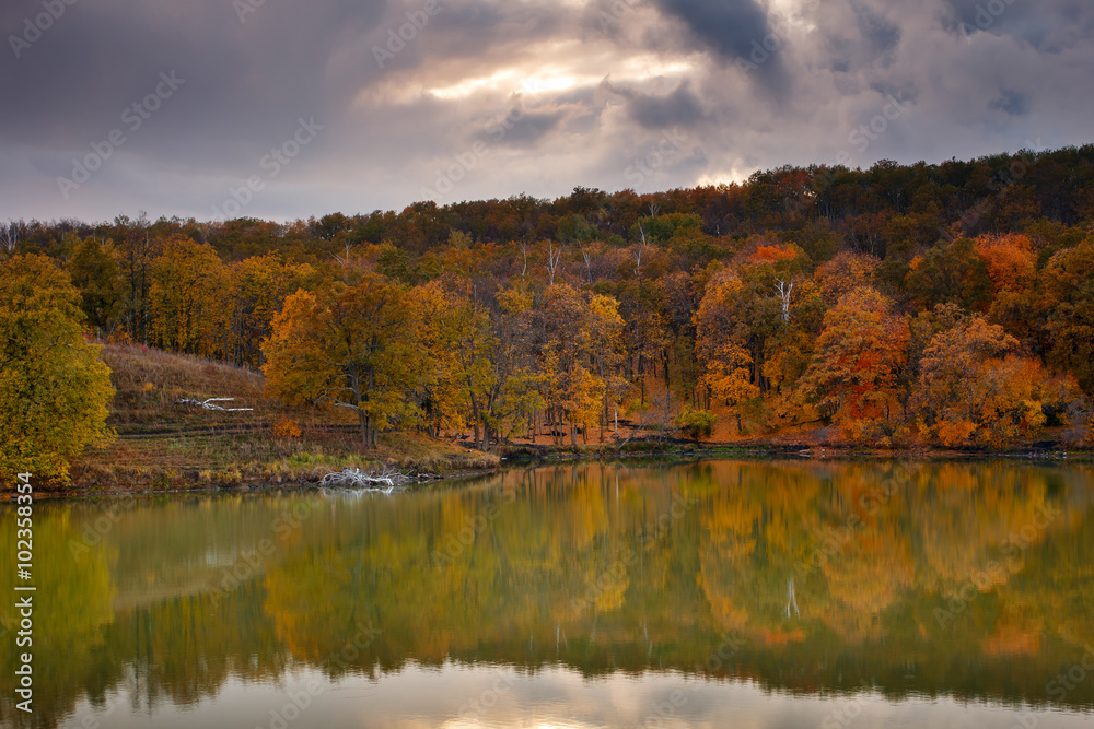 Beautiful nature landscape. Autumn fall forest reflected on lake