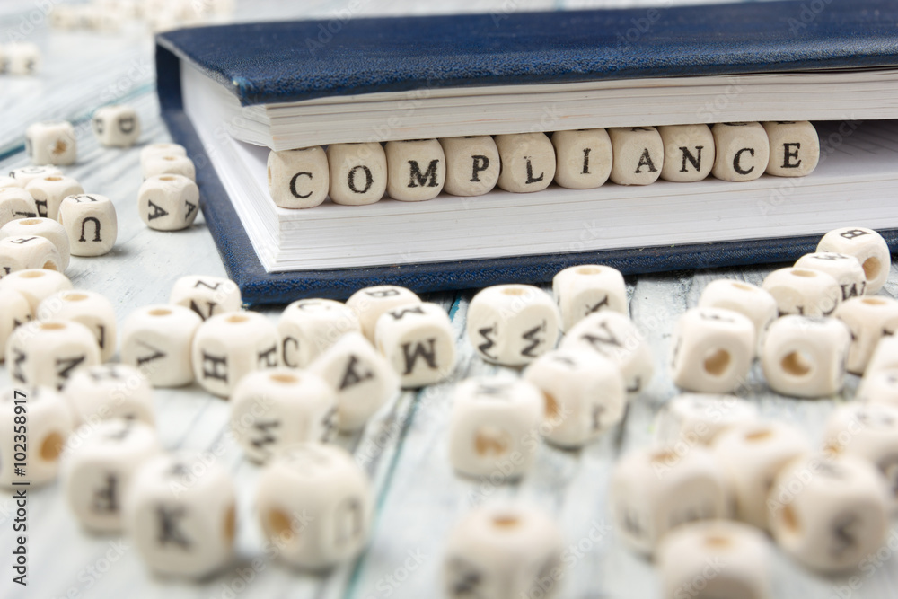 Compliance word written on wood block. Compliance word written on wood block.