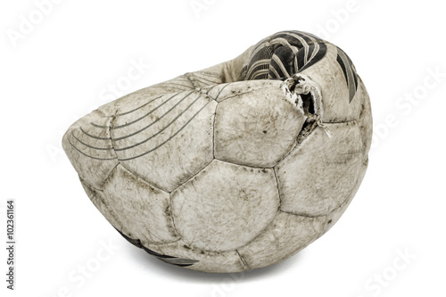 Old torn soccer ball  isolated on white background
