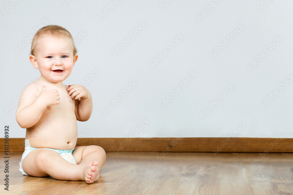 Cute smiling baby sitting at home. Cute smiling baby sitting at home.