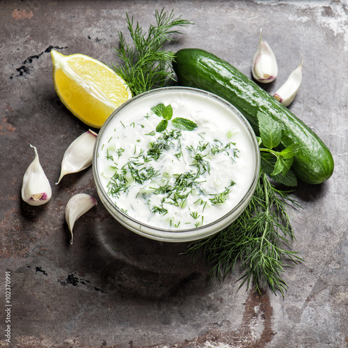 Fresh tzatziki yogurt sauce. Herbs and vegetables photo