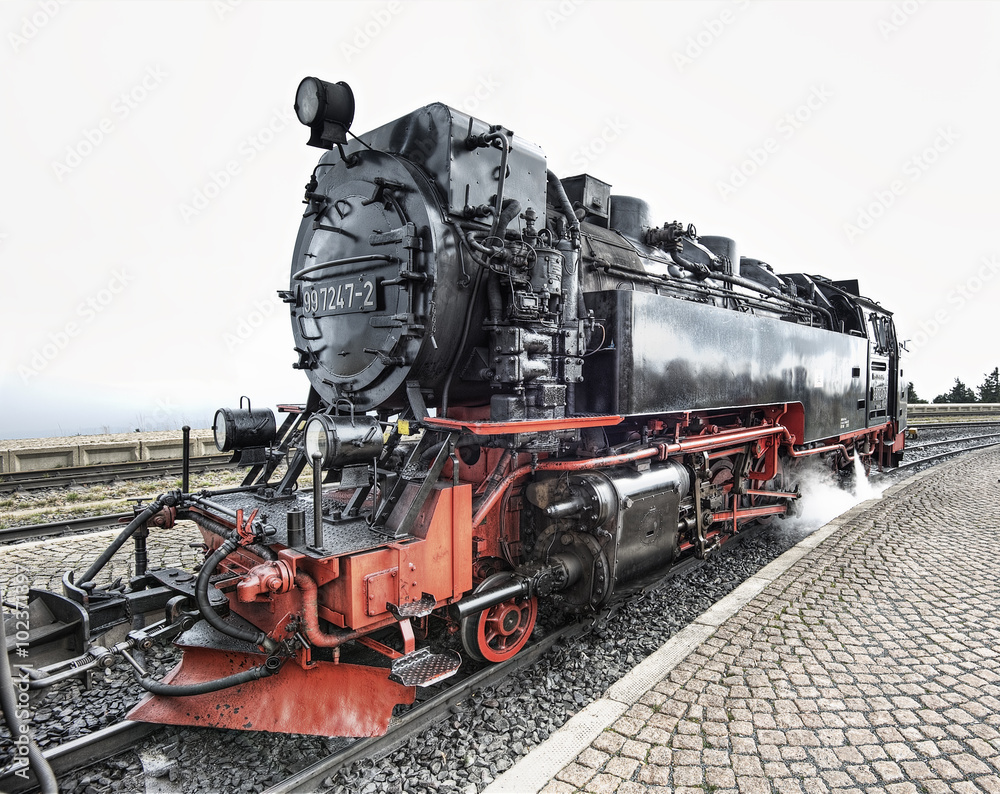 Obraz premium historic German black steam powered railway train at Brocken station, Brocken, Harz, Germany, Europe