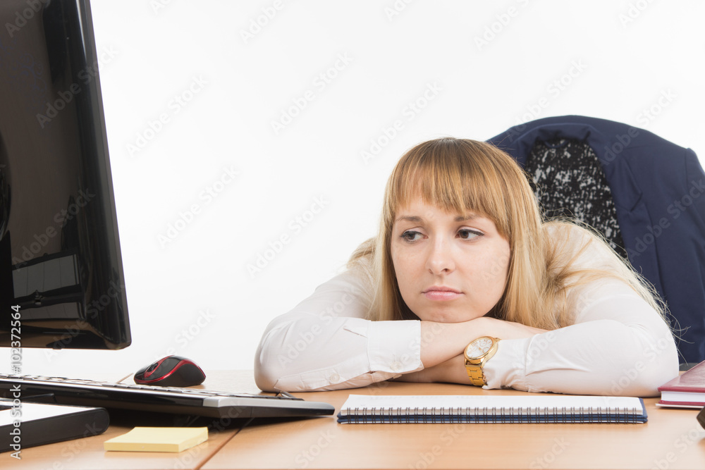 Sad office a specialist looks at a monitor screen Sad office a specialist looks at a monitor screen
