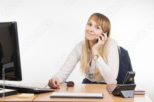 Office Specialist talking on a cell phone in the workplace