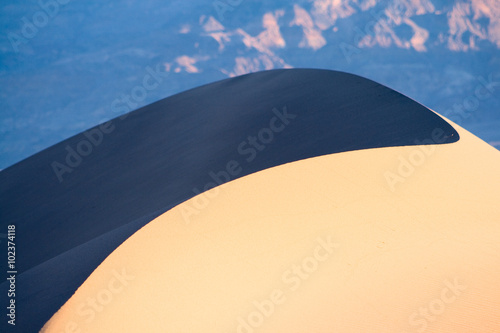 Yin and Yang - Morning sun sunlight casts a deep shadow on the back of a sand dune in Death Valley National Park.