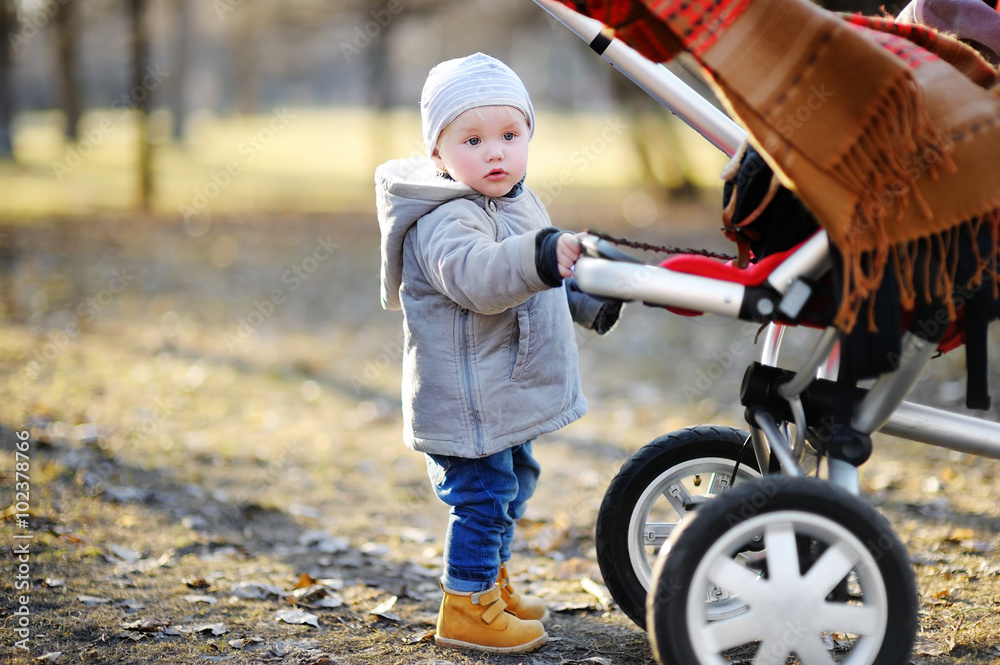 Toddler walking outdoors at the warm spring day Toddler walking outdoors at the warm spring day