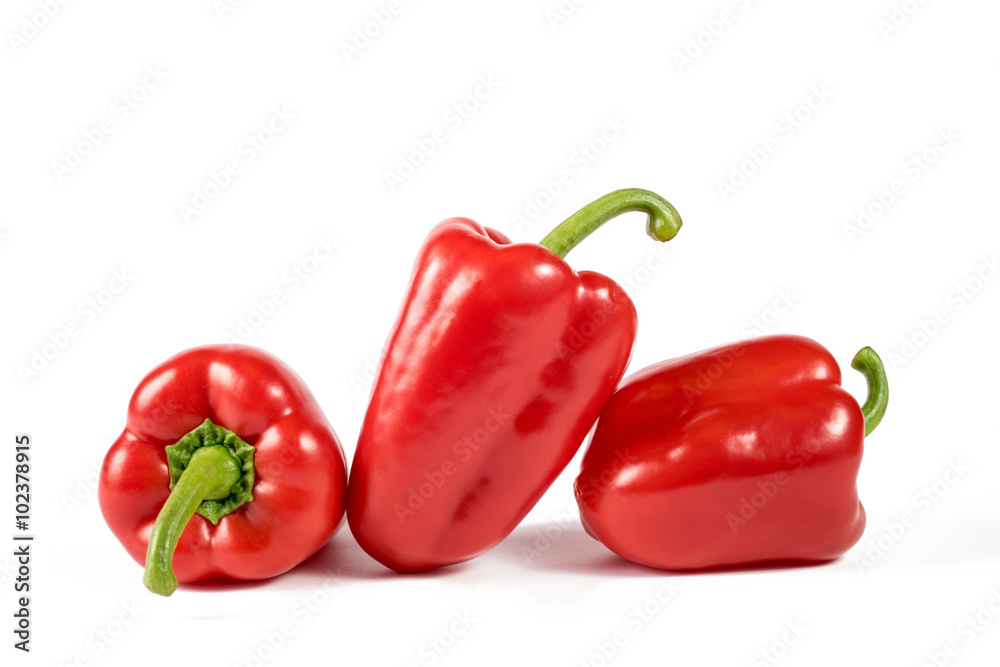 Three ripe red sweet peppers isolated on a white background